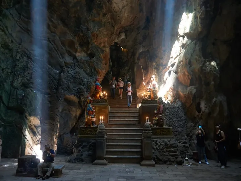 Huyen Khong Cave in Da Nang features natural skylights, a grand Buddha statue, and sacred altars, creating a serene and mystical spiritual retreat