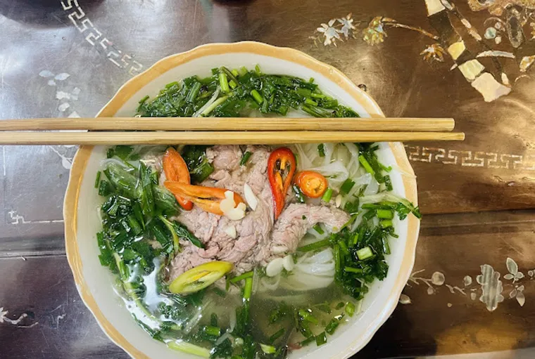 A steaming hot bowl of classic Beef Pho, a must-try in Hanoi